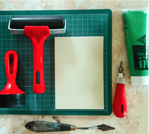 Essdee red handles roller, brayer, piece of SoftCut and green block printing ink