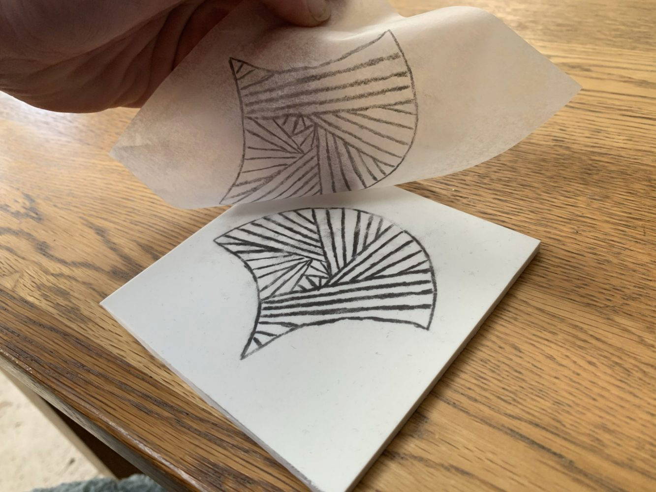 Fan image being transferred from tracing paper onto softcut material