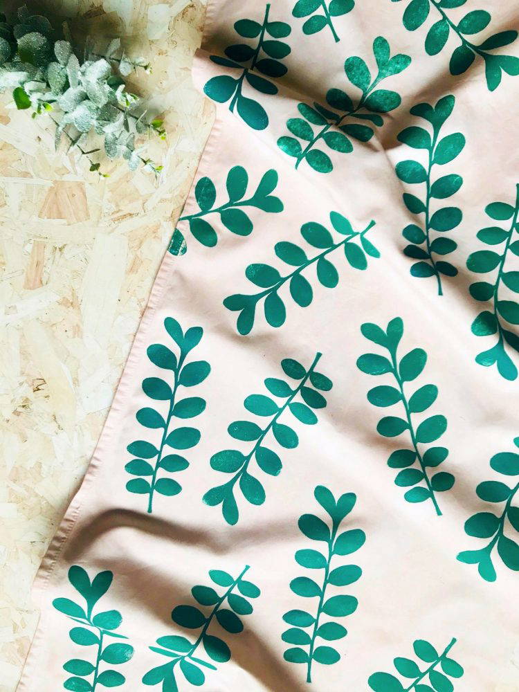 Cream fabric with green printed leaves