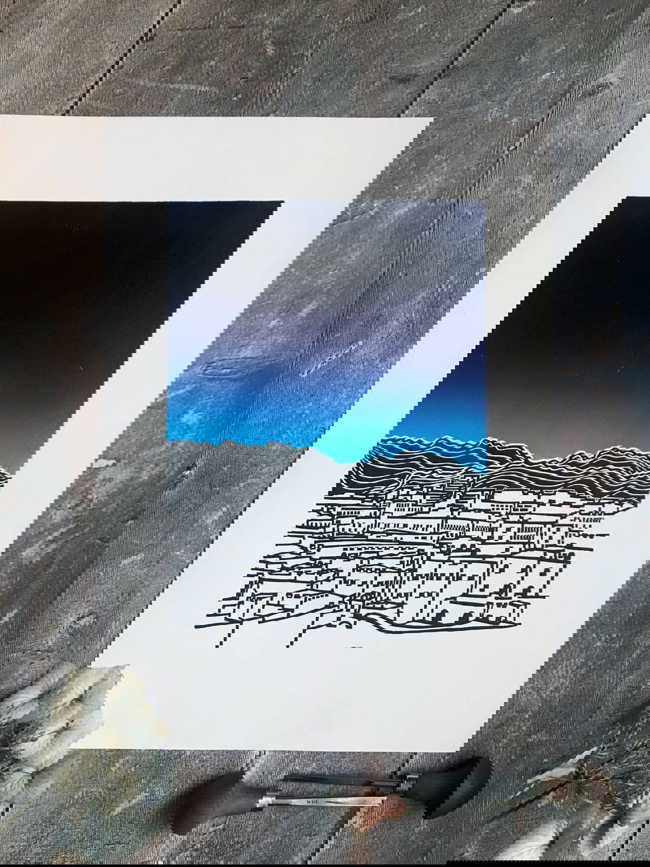 Night scene Lino print of city with a brilliant blue sky