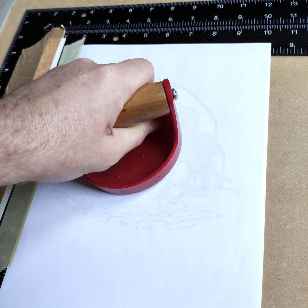 Ladybird linocut blog 5 baren being used to transfer printed monstera leaf onto paper