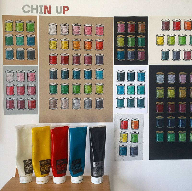 Cotton reels on different backgrounds Fan image printed in black onto paper next to mastercut stamp