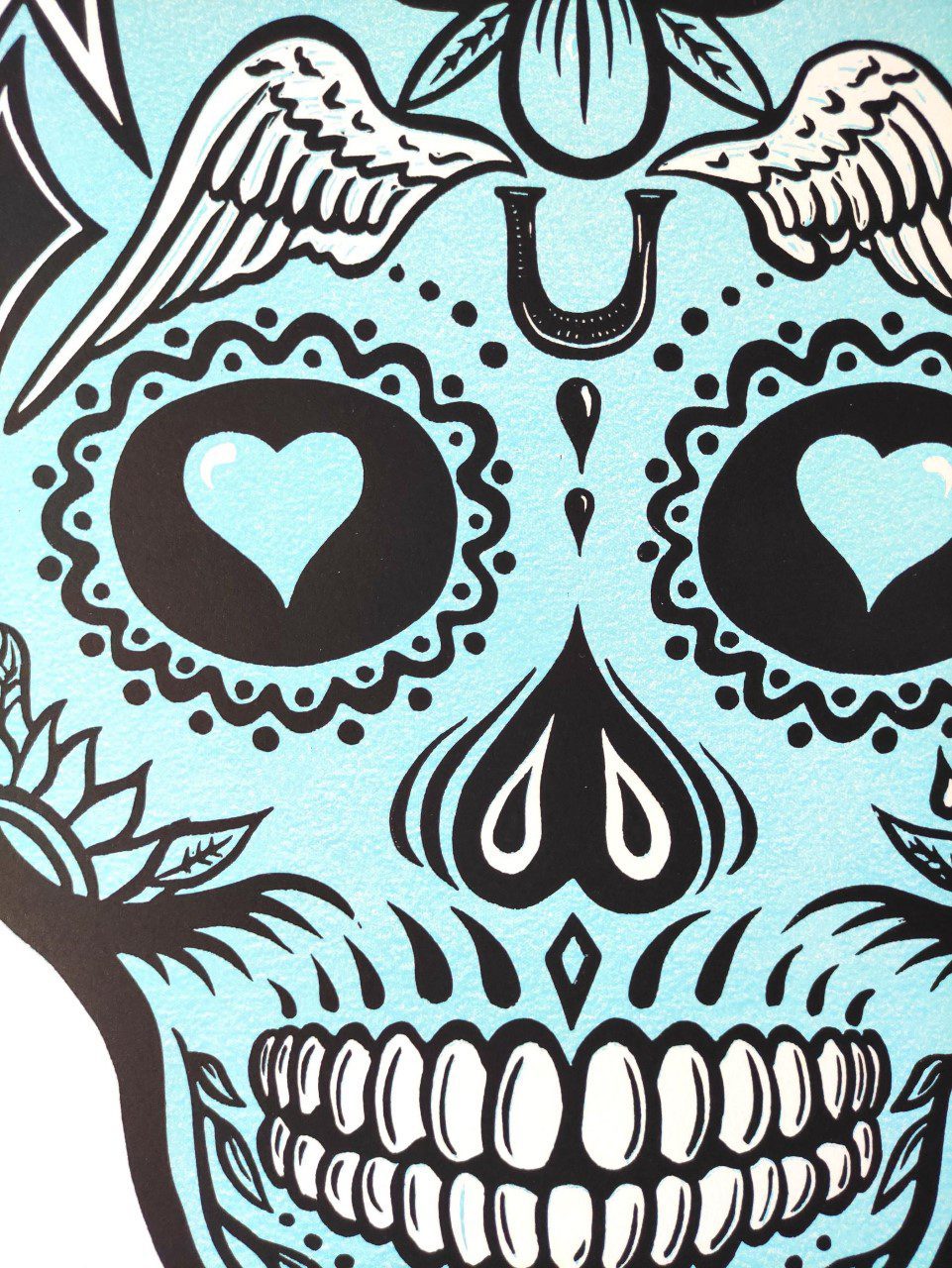 Lino print of pale blue and black skull