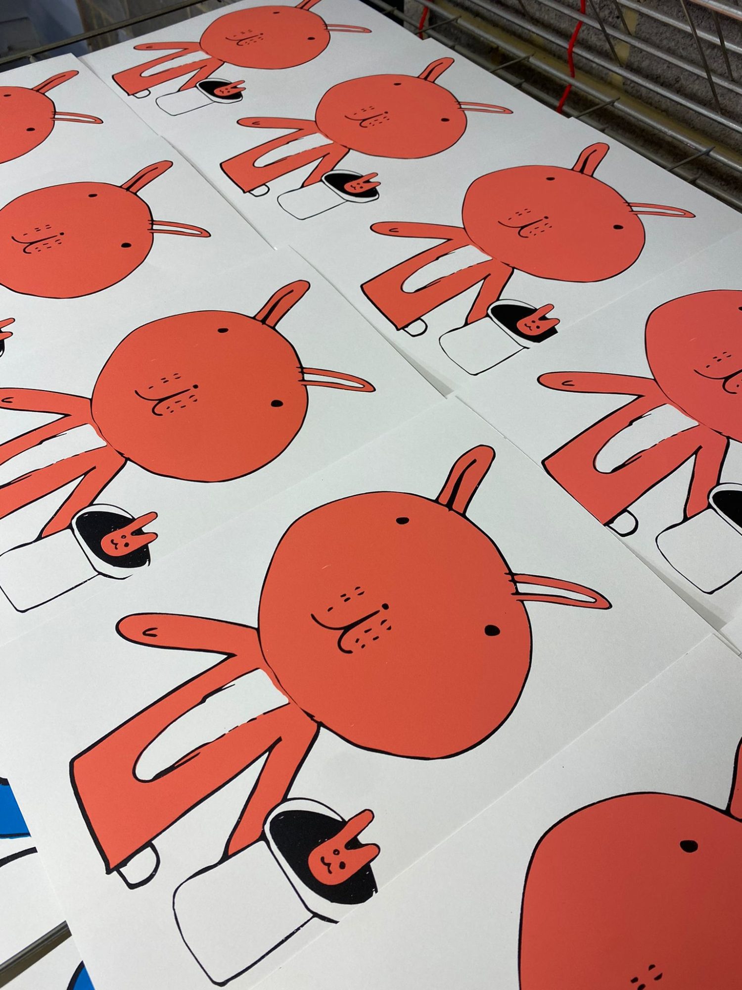 Children learning to linoprint using a press