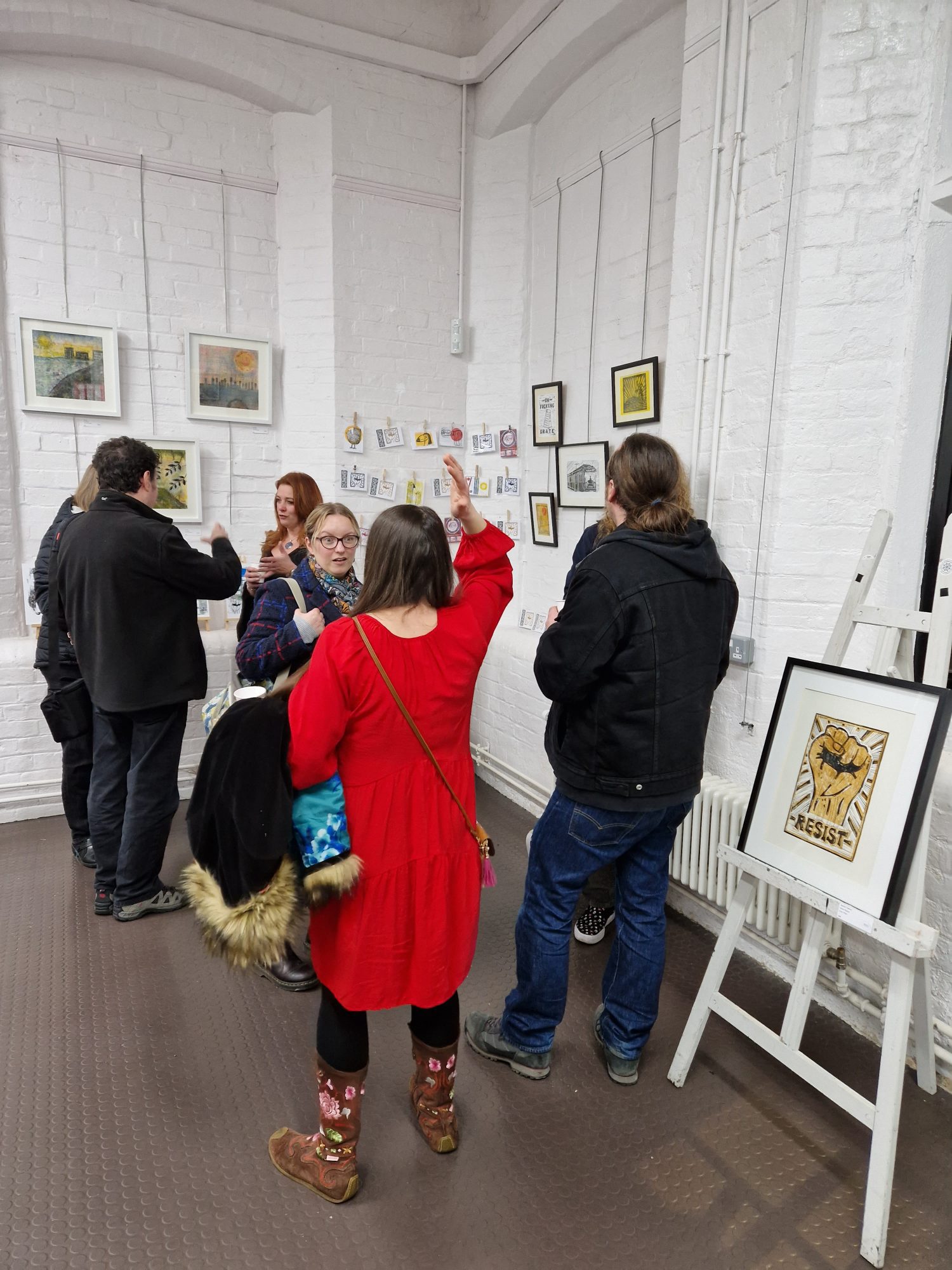 People attending an exhibition of linoprints by Dave Elsom