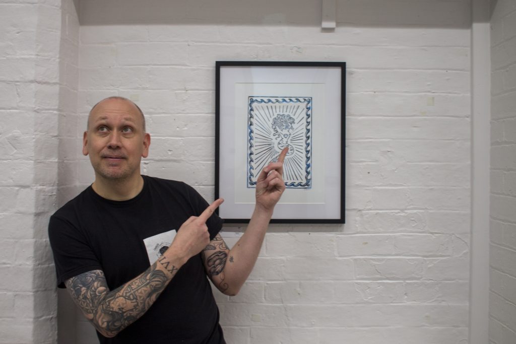 Linoprint artist Dave Elsom in front of one of his linoprints