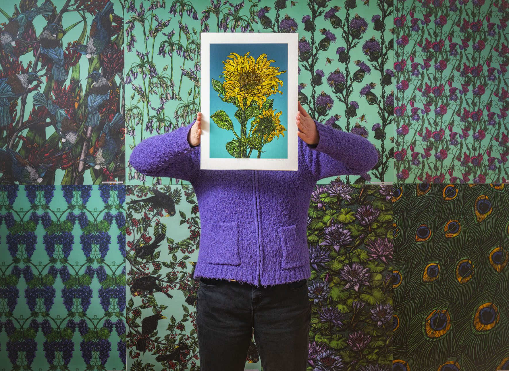 Photo of Rachel Meehan holding a sunflower scraperboard piece of art