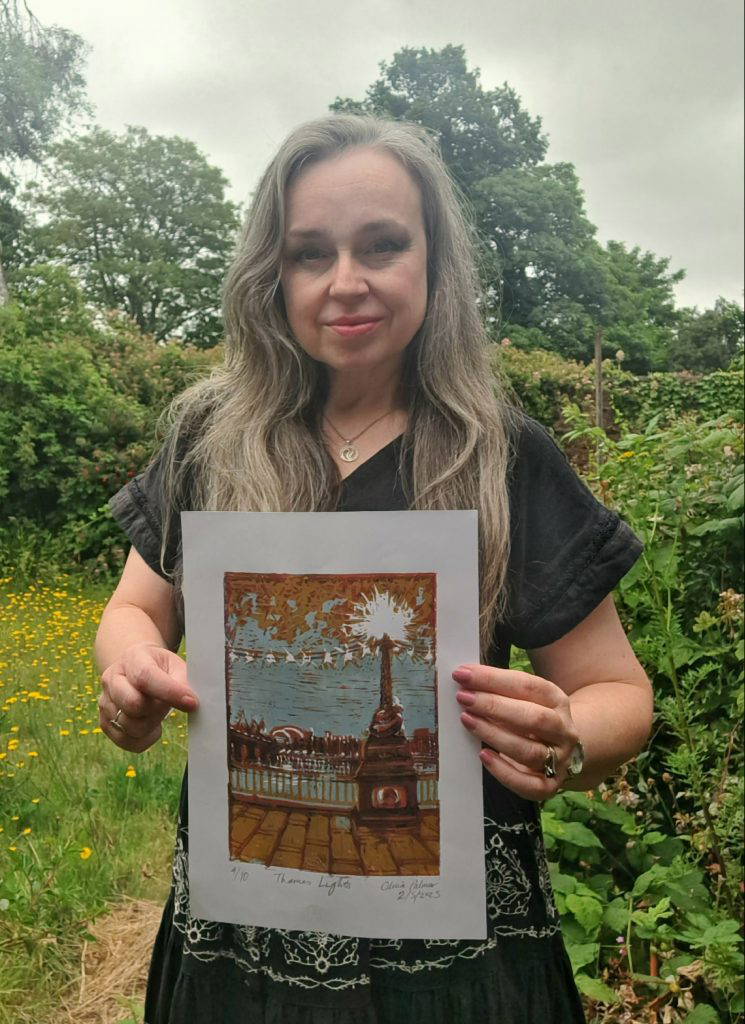 Olivia Palmer holding her Lino Print